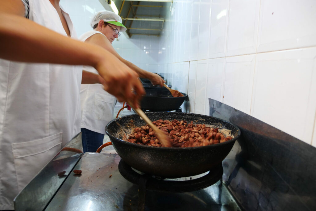 Deux femmes cuisinent des amandes dans des plats ressemblant à des woks